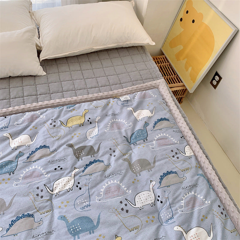 Children's quilt with colorful dinosaur print and soft minky border