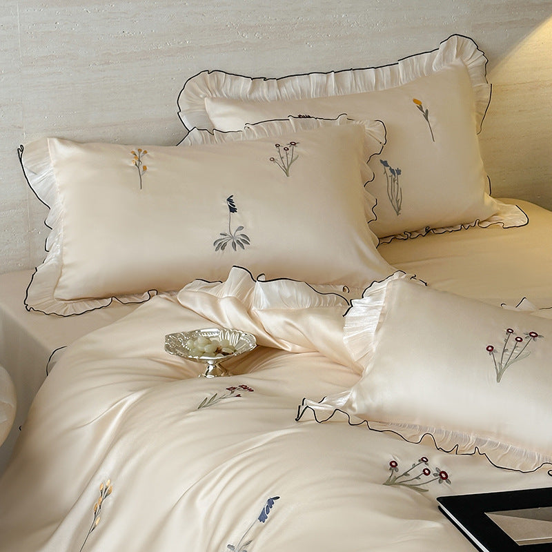 Satin bedding set with pleated frill and delicate embroidery
