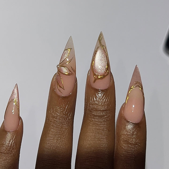 Artful Stiletto Nails with Gold Accents Kalsten