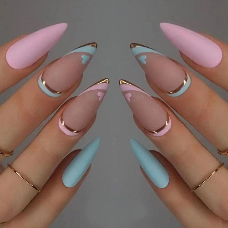 Artistic stiletto nails with gold accents and heart design Kalsten