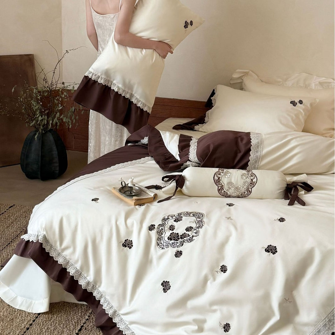 Luxurious embroidered bedding set with ruffle and decorative roll Kalsten