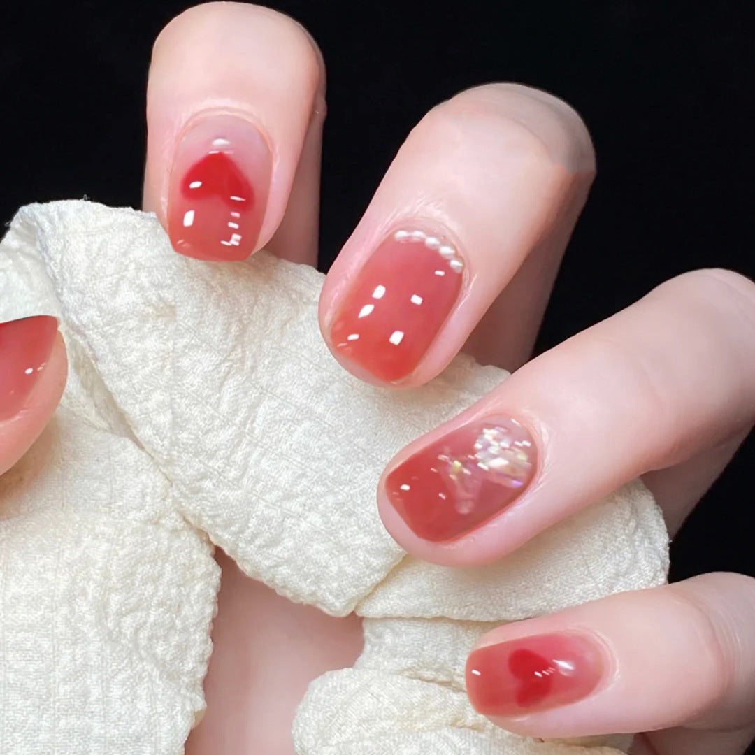 Artful nail art with radiant shine and heart motifs Kalsten