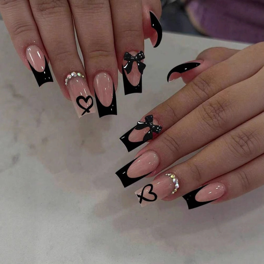 Acrylic nail set with elegant heart and bow design Kalsten