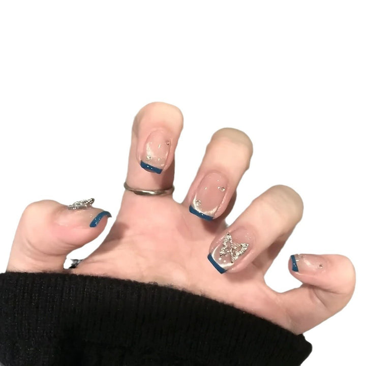 Artificial nails with trendy French tips and decorative glitter accents Kalsten