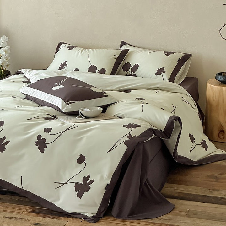 Reversible cotton satin bedding set with floral silhouette print and contrasting piped edge