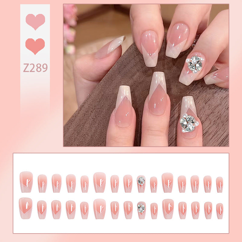 Artificial nail set with filigree tip designs and glamorous rhinestone accents Kalsten