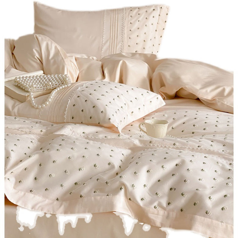 Exclusive satin bedding set with all-over rosebud embroidery and pleating details