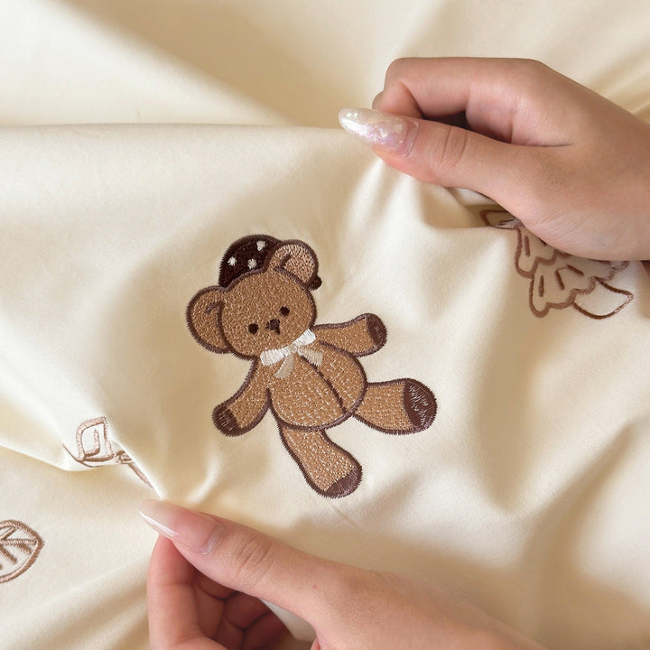 Embroidered bedding set with ruffled trim, teddy design and decorative pillow