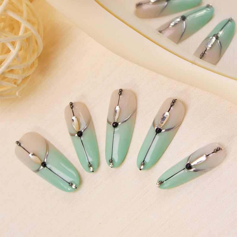 Acrylic nail set with elegant ombre effect and glamorous embellishments Kalsten