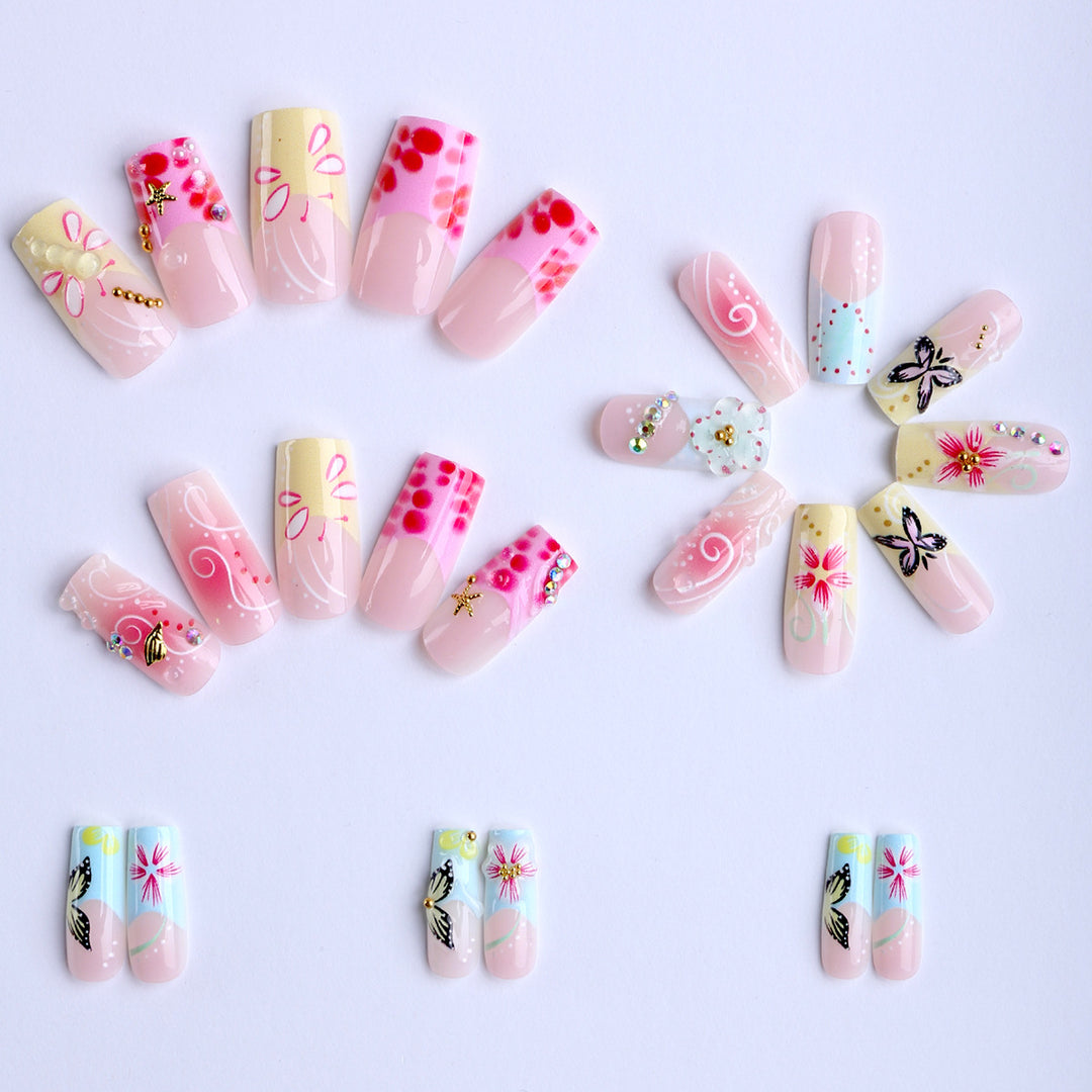 Artistic nails with floral accents and glitter clusters Kalsten