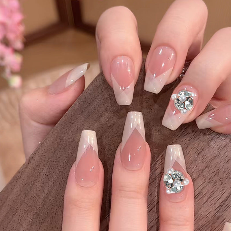 Artificial nail set with filigree tip designs and glamorous rhinestone accents Kalsten