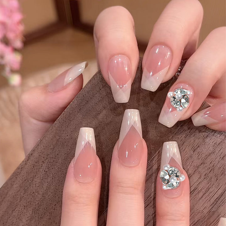 Artificial nail set with filigree tip designs and glamorous rhinestone accents Kalsten