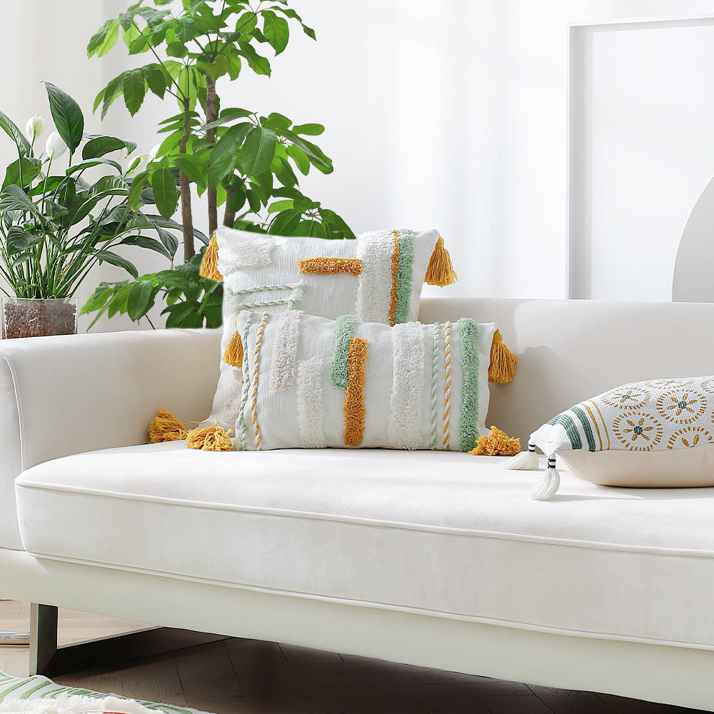 woven decorative cushion cover with tufted relief stripes and corner tassels
