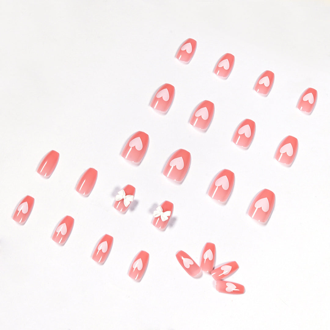Artistic acrylic nails with heart and bow motifs Kalsten