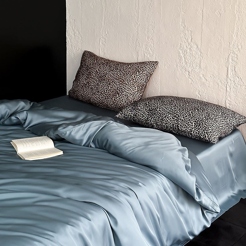 Satin bedding set with a silky sheen, smooth drape, and animal print pillows