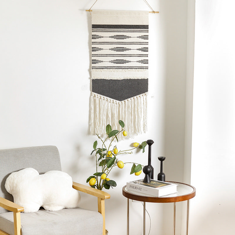 Handwoven wall hanging made of cotton blend with layered textures, wood rod and long fringes Kalsten