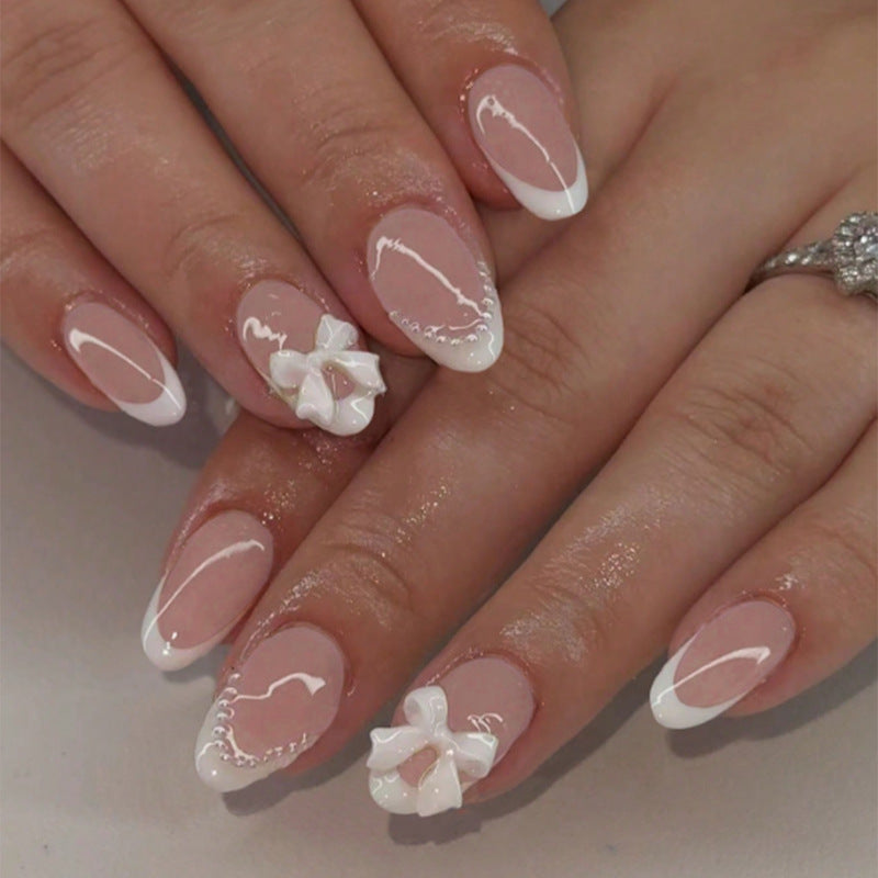 Acrylic nail set with elegant floral embellishments and trendy French tip Kalsten