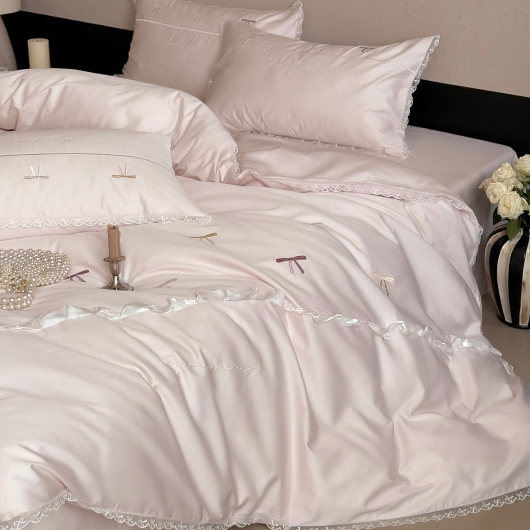Elegant bedding set made of silky fine satin with embroidered bows and lace trim