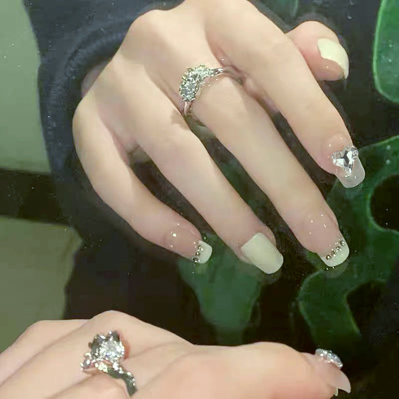 Glamorous artificial nails with heart and rhinestone decorations Kalsten