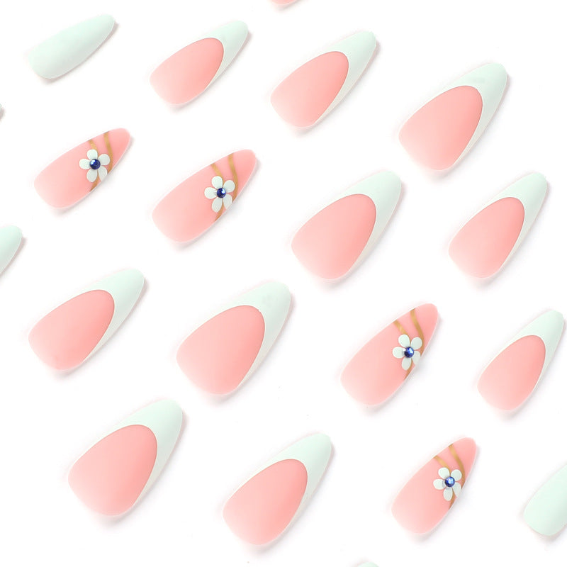 Artistic stiletto nails with floral accents and glitter embellishments Kalsten