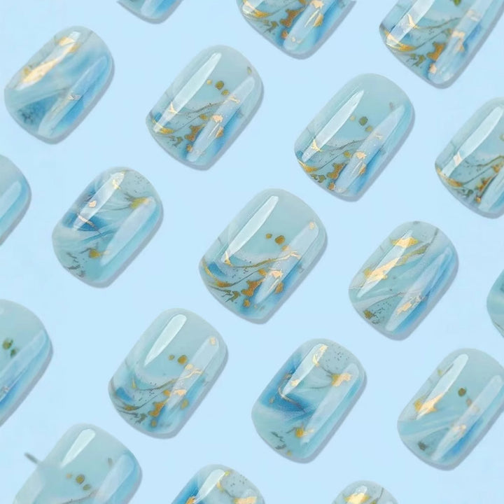 Acrylic nail set with luxurious marble design and gold accents Kalsten