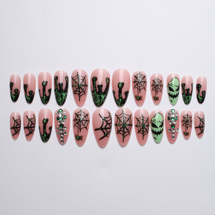 Acrylic nails with Halloween spider design and glitter accents Kalsten