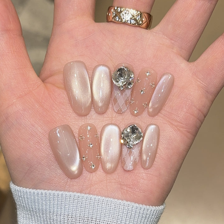 Elegant artificial nails with shimmering effects and rhinestone accents Kalsten