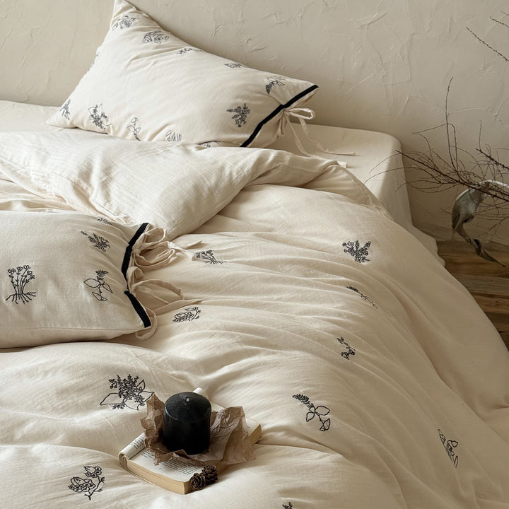 Breathable cotton-linen bedding set with delicate floral embroidery and bow closure