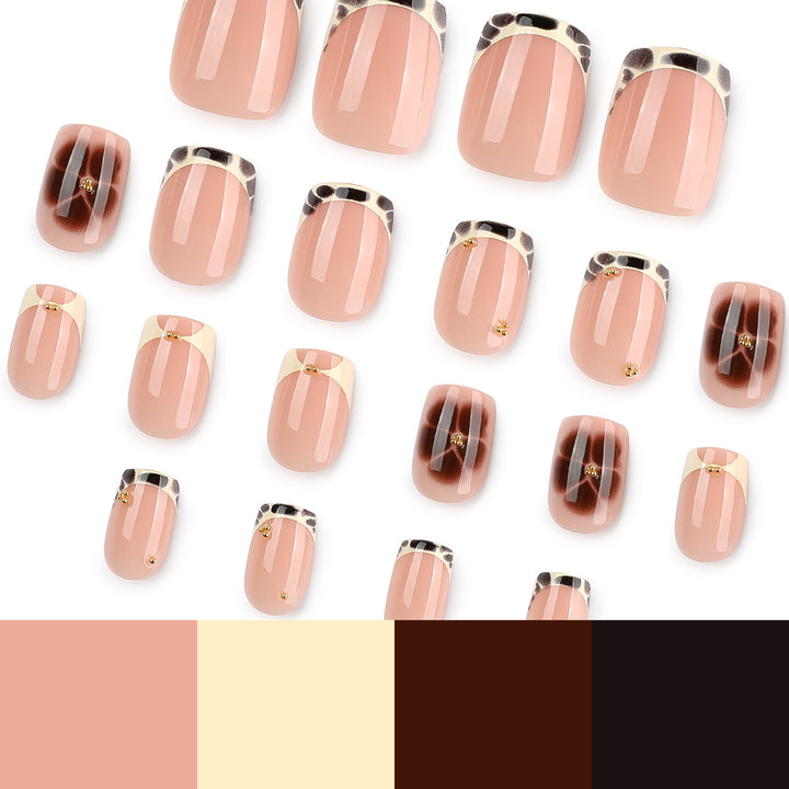 Artful nail extensions with an elegant giraffe pattern and golden accents Kalsten
