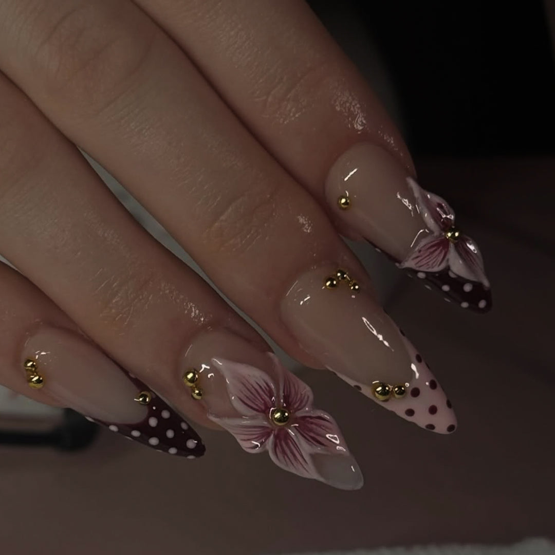Artful stiletto nails with floral accents and glitter Kalsten