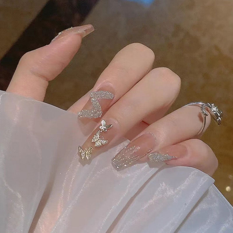 Glamorous artificial nails with heart design and glittering accents Kalsten