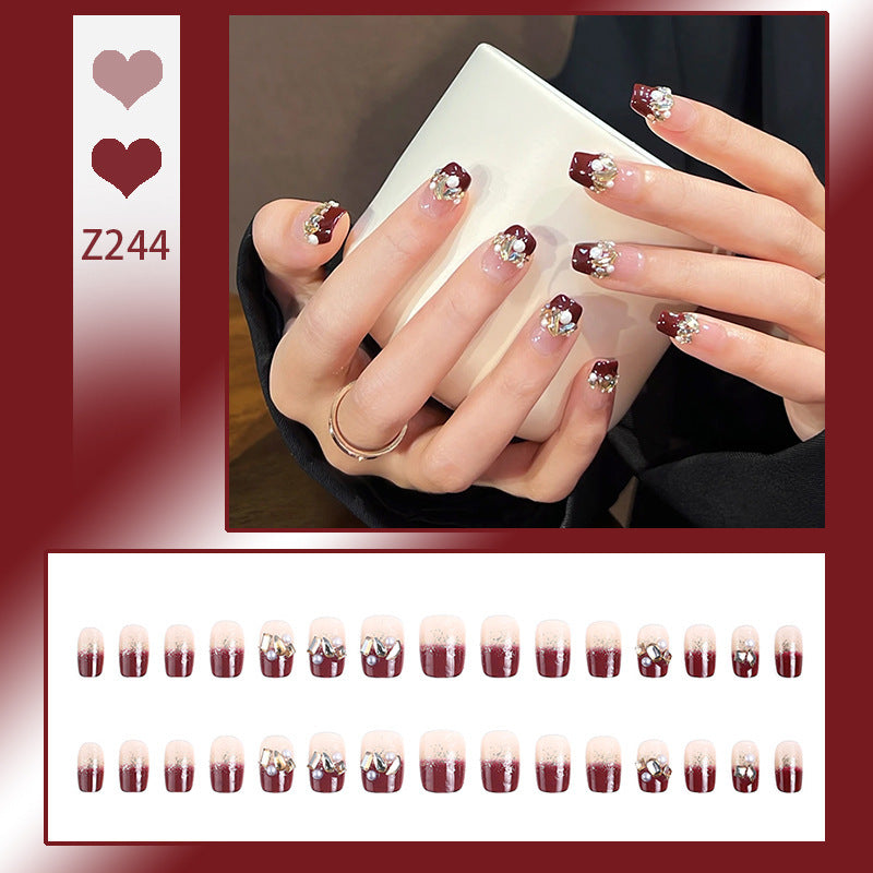 Glamorous artificial nails with decorative pearl and glitter embellishments Kalsten