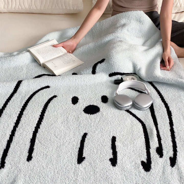Reversible cuddly blanket made of terry cloth with decorative dog motif