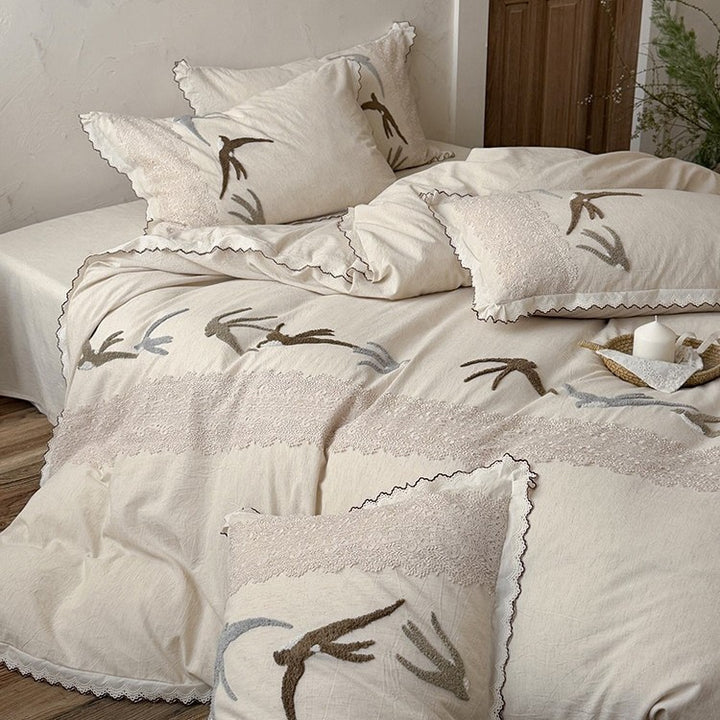 High-quality bedding set with embroidered swallows, lace trim and linen look