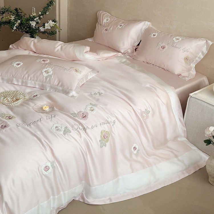 Luxurious satin bedding set with embroidered rose appliqués and silky glossy finish
