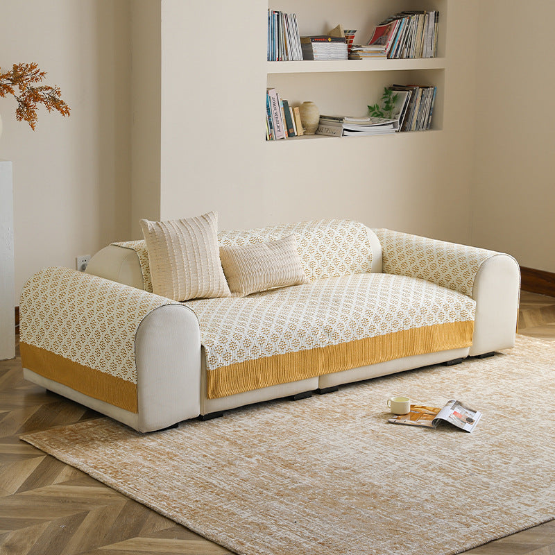 Knitted sofa cover with jacquard pattern and reinforced hem border Kalsten