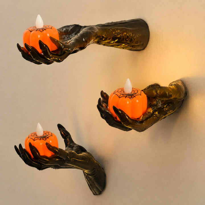 Wall candle holder in realistically shaped hand made of resin