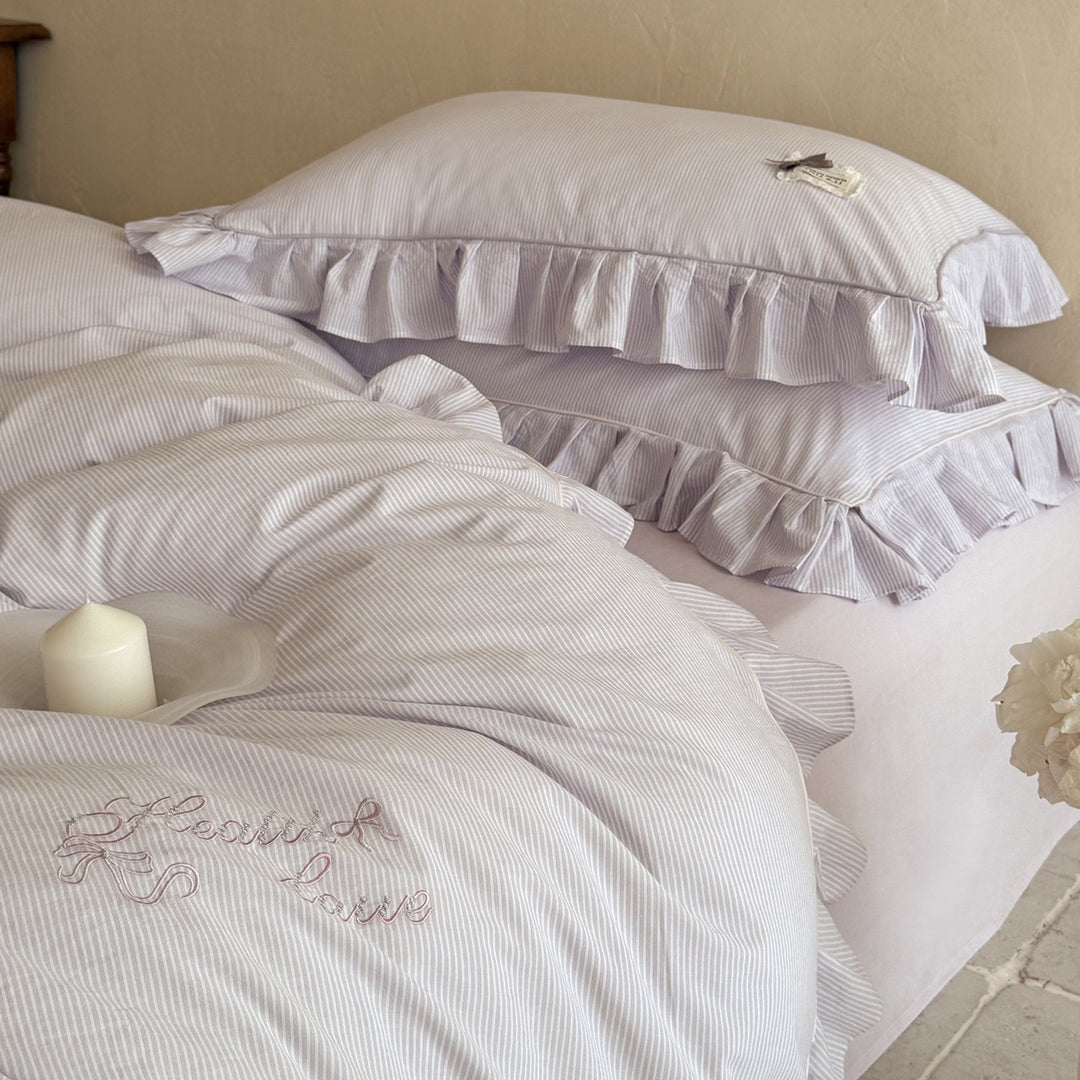 Ruffled bed linen set with fine striped texture and decorative frill