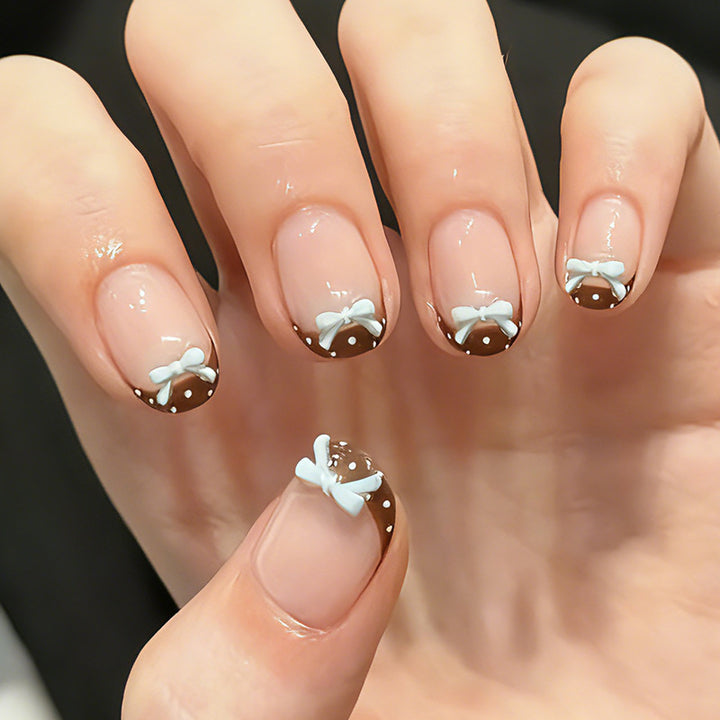Artificial nail set with playful bows and elegant dots Kalsten