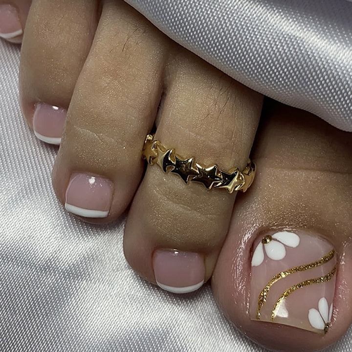 Nail art with elegant blooming designs and glitter accents Kalsten