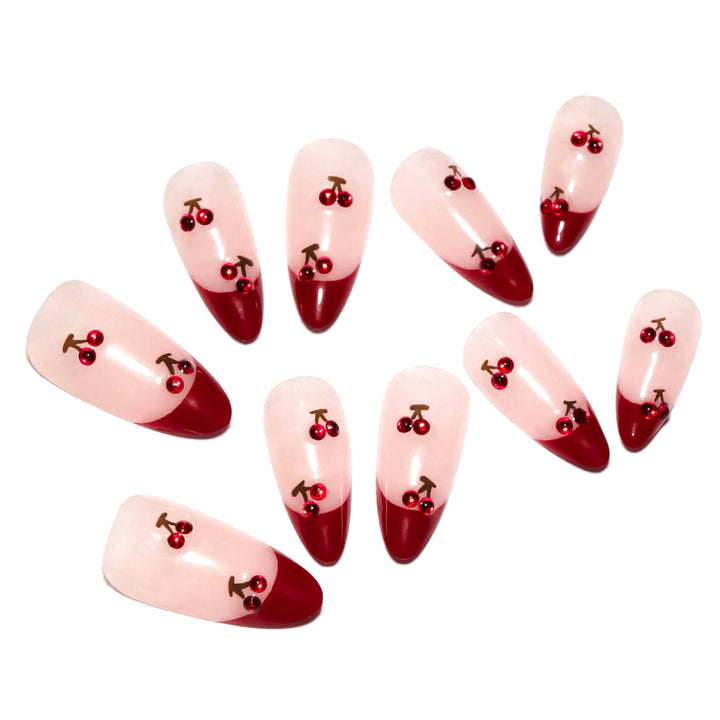 Artful stiletto nails with cherry motifs and glitter accents Kalsten