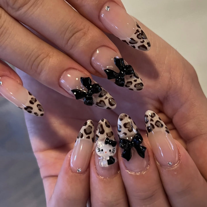 Artistic extension nails in leopard pattern with bow accents Kalsten