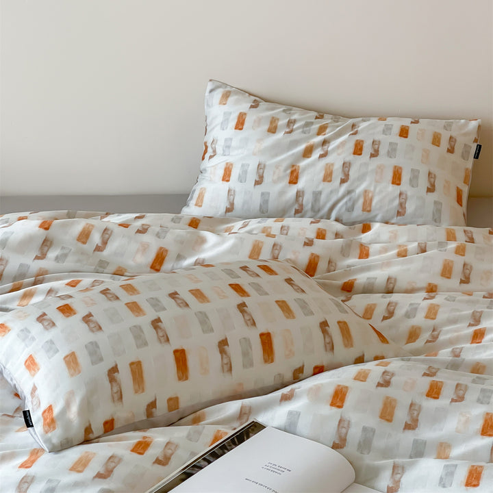 Luxurious satin bedding set with floral watercolor print, ruffled edges and reversible function