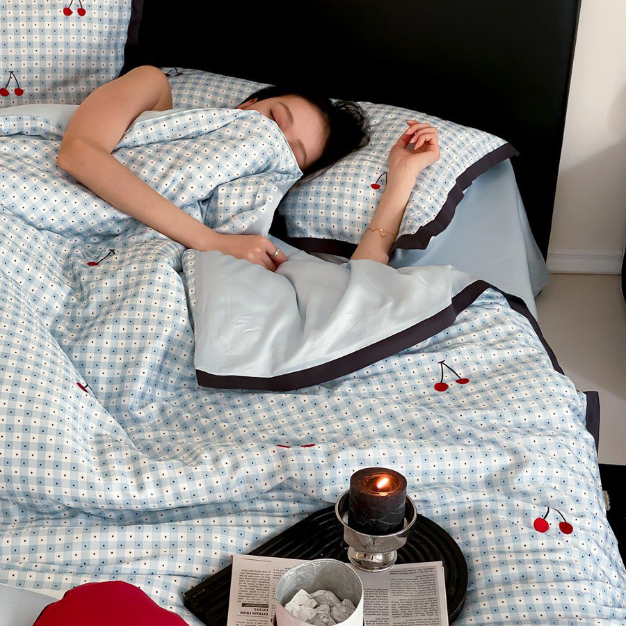 Playful cotton satin bedding set with cherry print and fine check pattern