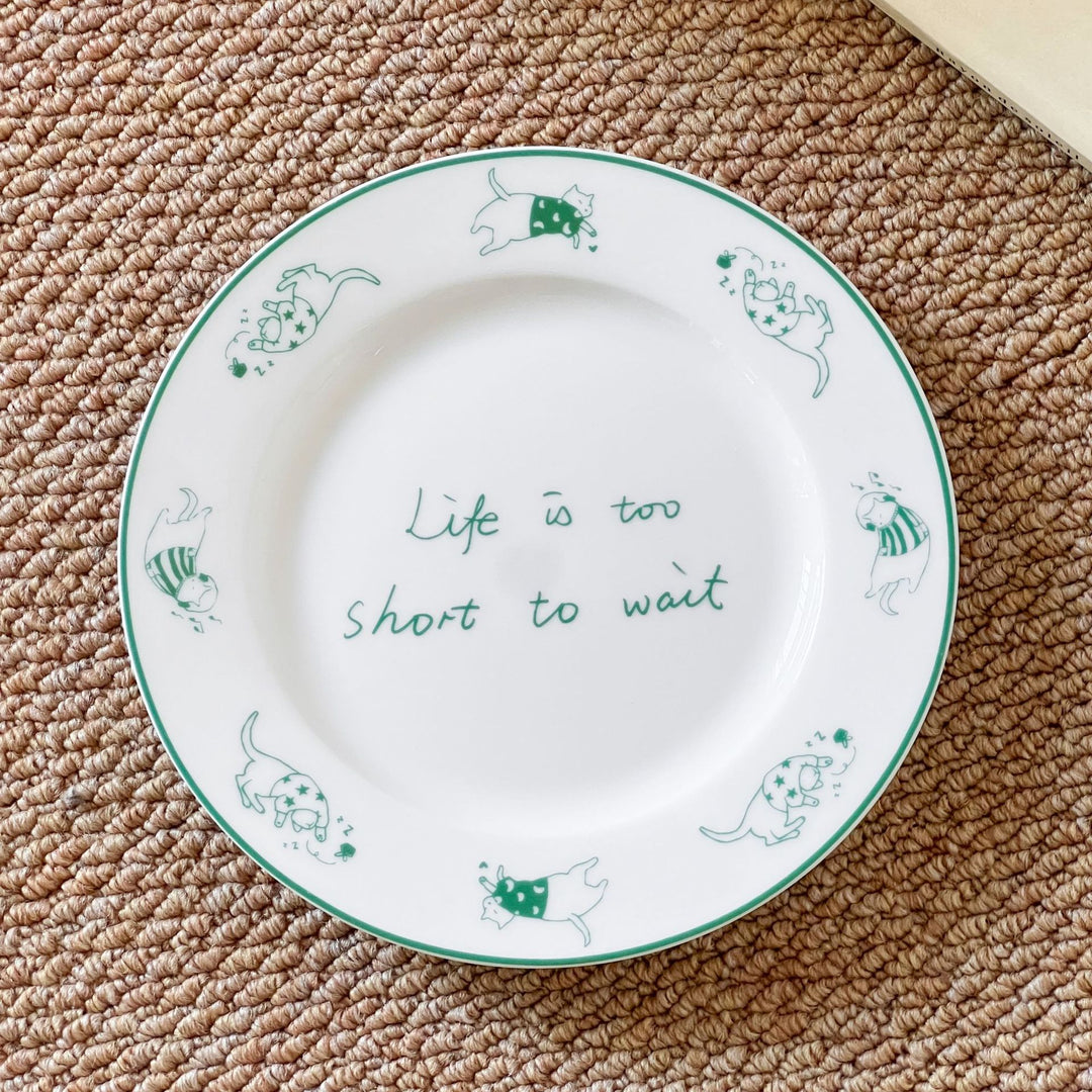 Decorative ceramic plate with cat motif and green border decoration