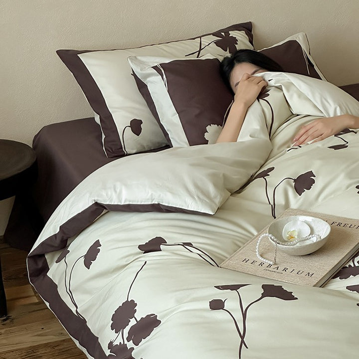 Reversible cotton satin bedding set with floral silhouette print and contrasting piped edge