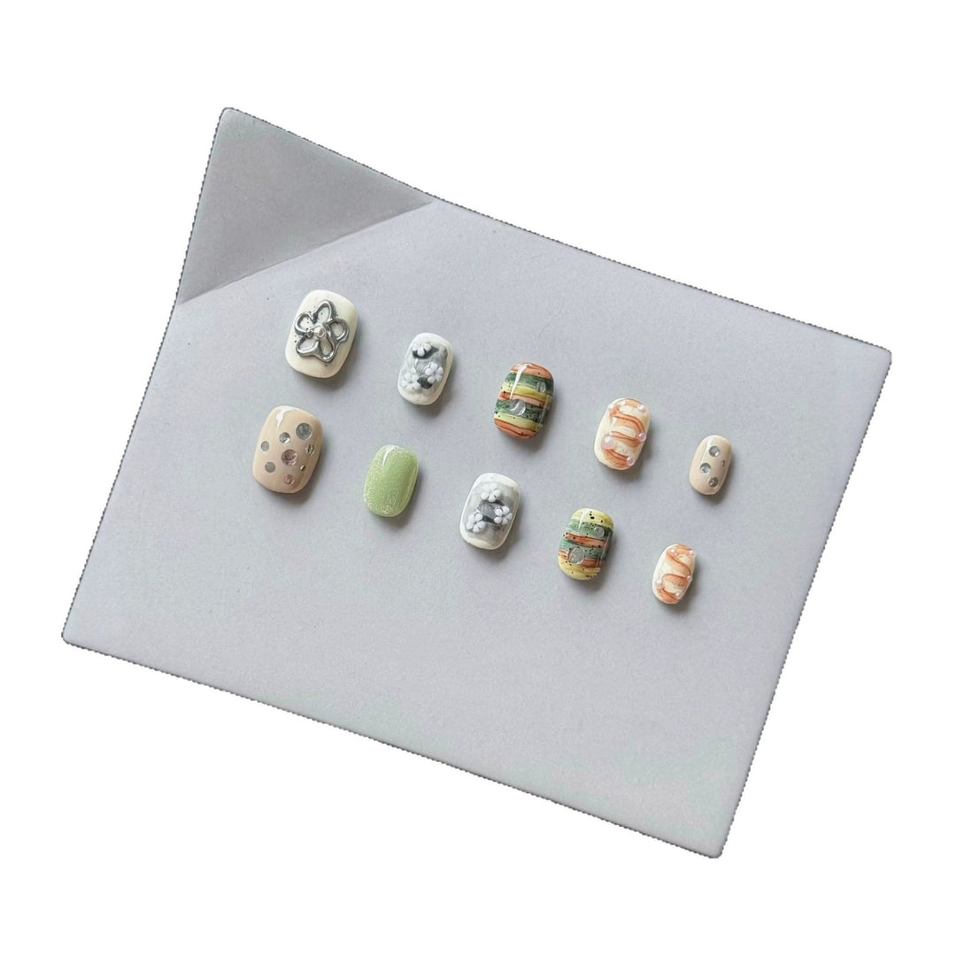 Artistic Press-On Nail Set with Floral and Textured Designs