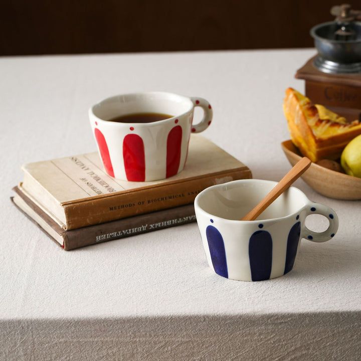 Handmade ceramic mug with ergonomic handle and wavy rim