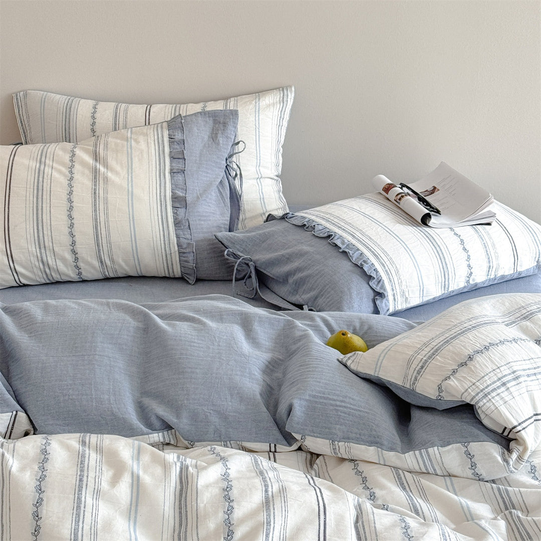 Striped bedding set made of washed linen-cotton mix with fine ribbon embroidery and tie band pillow