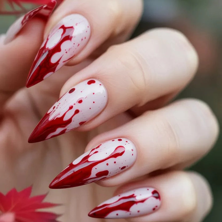 Artificial nail set with blood red inspired design and pointed accents Kalsten